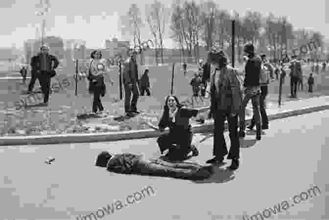 A Black And White Photograph Of A Group Of Students Running Away From A Line Of National Guardsmen With Their Guns Raised. Kent State Deborah Wiles