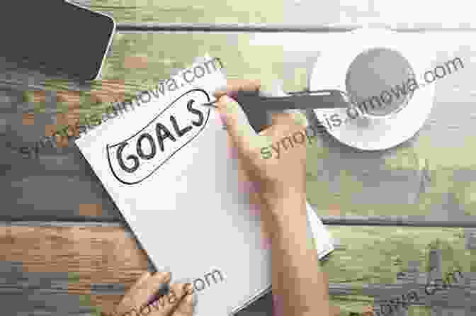 A Person Writing Down Goals, Representing The Process Of Empowered Goal Setting Agile Scrum: Your Quick Start Guide With Step By Step Instructions: Deliver Products In Short Cycles With Rapid Adaptation To Change Fast Time To Market And Continuous Improvement