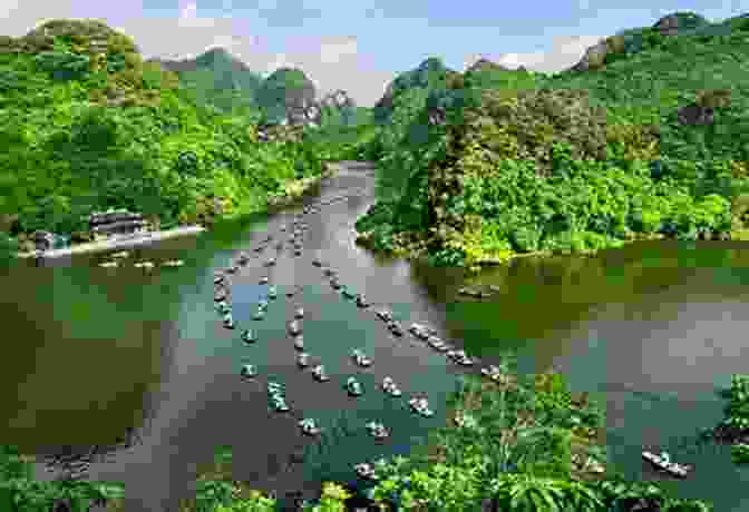 A Sampan Boat Glides Through The Trang An Grottoes In Ninh Binh Vietnam: Hanoi Ha Long Bay Ninh Binh